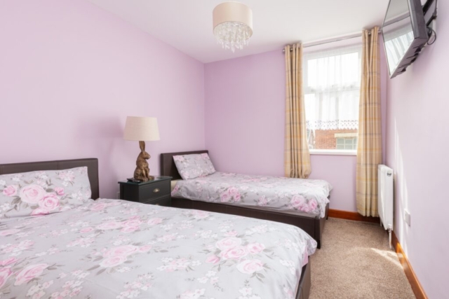 Self catering holiday apartments Blackpool. Beachcliffe apartments  7 twin bedroom, has two single beds, bedside cabinet, wall mounted TV, wardrobe. radiat