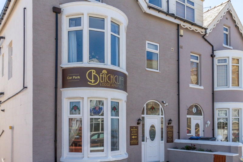Self catering holiday apartments Blackpool. Beachcliffe apartments  exterior has a front garden and outdoor seating area.
